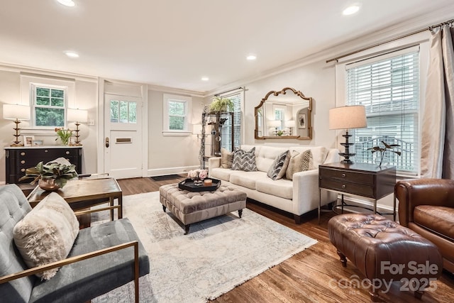 living area with ornamental molding, recessed lighting, and dark wood finished floors