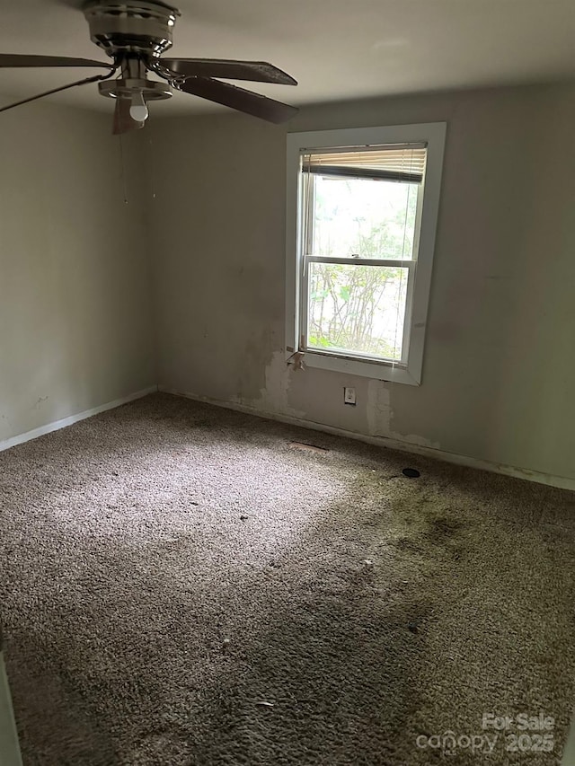 unfurnished room with ceiling fan, carpet floors, and baseboards