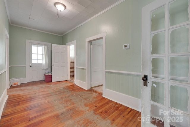 302 Charlotte St, York, SC 29745 - empty room featuring crown molding, a wainscoted wall, and light wood-style floors