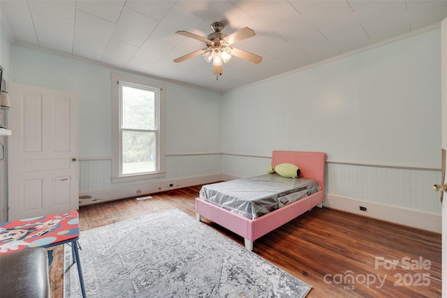 302 Charlotte St, York, SC 29745 - bedroom featuring wainscoting, a ceiling fan, wood finished floors, and ornamental molding