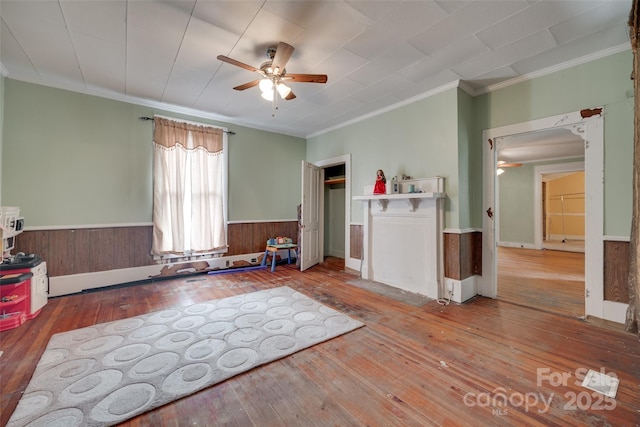 302 Charlotte St, York, SC 29745 - interior space featuring a wainscoted wall, ornamental molding, ceiling fan, and wood-type flooring
