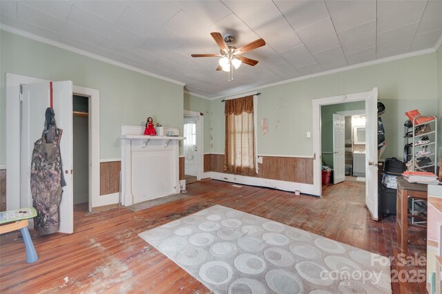 302 Charlotte St, York, SC 29745 - living area featuring hardwood / wood-style flooring, a ceiling fan, a wainscoted wall, and crown molding