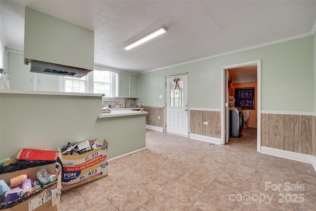 302 Charlotte St, York, SC 29745 - playroom featuring a wainscoted wall, wood walls, independent washer and dryer, and crown molding