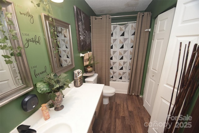 full bath with wood finished floors, toilet, vanity, a textured ceiling, and shower / bath combo
