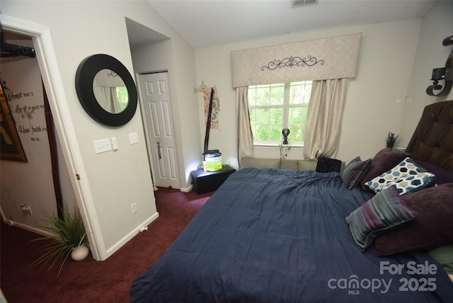 bedroom with visible vents, vaulted ceiling, carpet floors, and baseboards