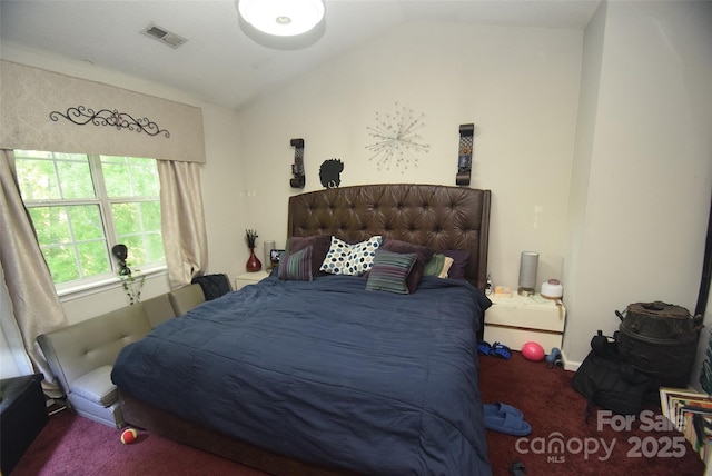 bedroom featuring vaulted ceiling, visible vents, and carpet flooring