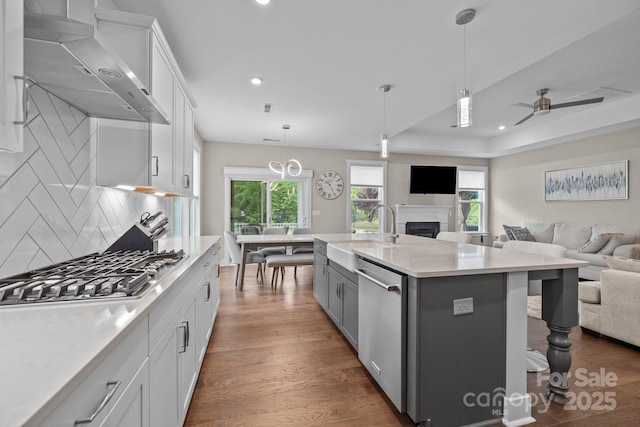 1548 Striped Bass Ln, Clover, SC 29710 - kitchen featuring a sink, light countertops, wall chimney exhaust hood, stainless steel appliances, and open floor plan