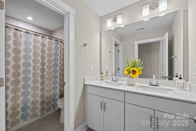 1548 Striped Bass Ln, Clover, SC 29710 - bathroom featuring double vanity, toilet, visible vents, and a sink