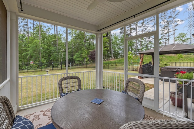 1548 Striped Bass Ln, Clover, SC 29710 - sunroom with outdoor dining area, a ceiling fan, and a hot tub