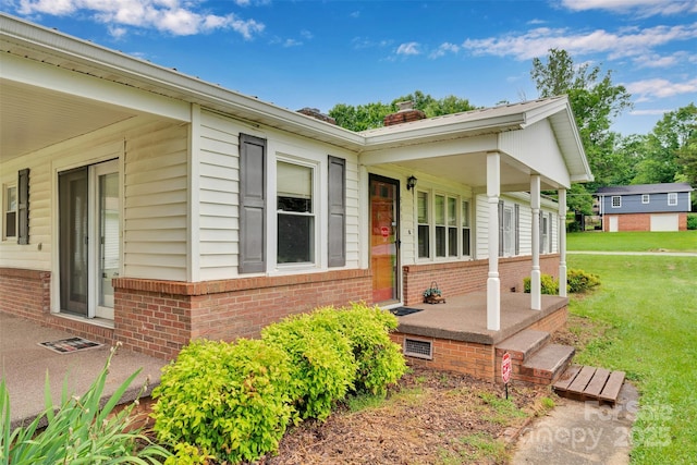 543 18th St NW, Hickory, NC 28601 - view of property exterior with brick siding, a lawn, a chimney, and a porch