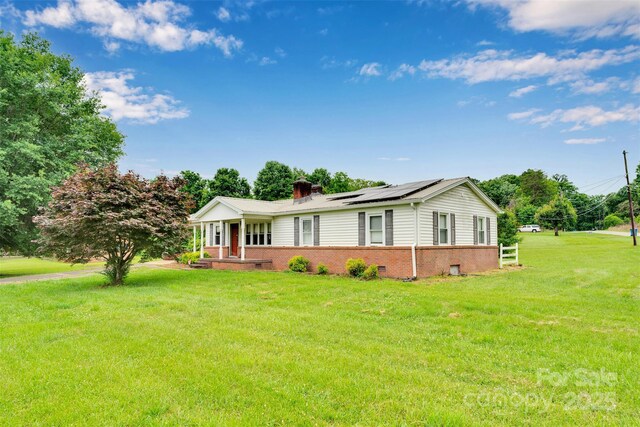 543 18th St NW, Hickory, NC 28601 - single story home with solar panels, a front yard, brick siding, and a chimney