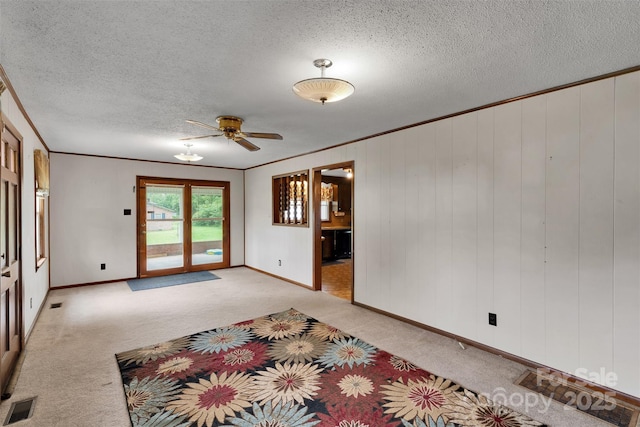 543 18th St NW, Hickory, NC 28601 - spare room featuring light colored carpet, a textured ceiling, a ceiling fan, baseboards, and ornamental molding