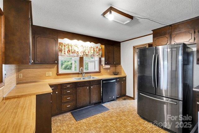 543 18th St NW, Hickory, NC 28601 - kitchen featuring freestanding refrigerator, dishwashing machine, a sink, light countertops, and a textured ceiling