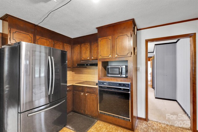 543 18th St NW, Hickory, NC 28601 - kitchen with black appliances, under cabinet range hood, light countertops, baseboards, and ornamental molding