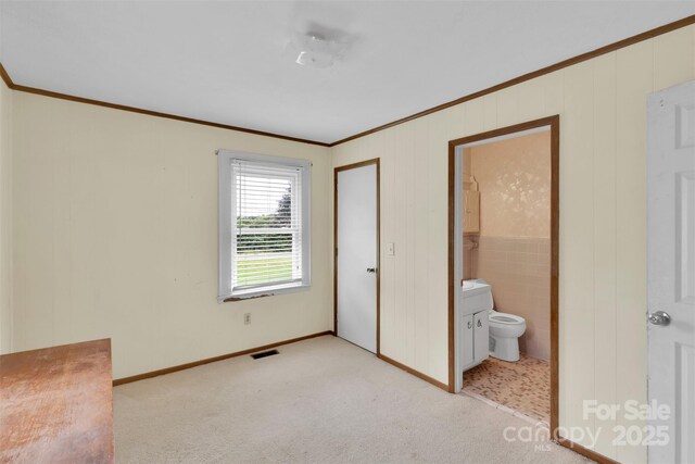 543 18th St NW, Hickory, NC 28601 - unfurnished bedroom featuring ornamental molding, light carpet, ensuite bathroom, and baseboards