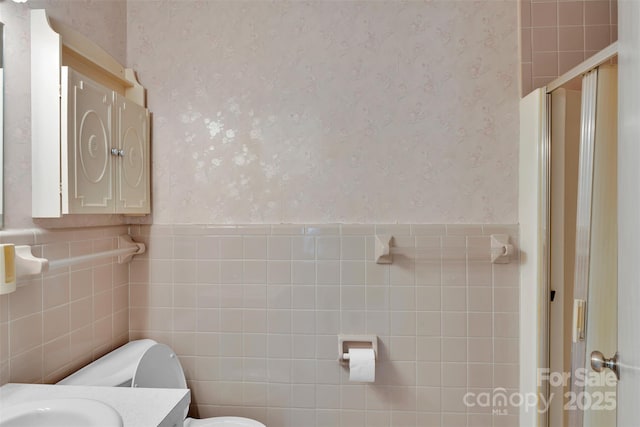 543 18th St NW, Hickory, NC 28601 - full bathroom with wallpapered walls, toilet, a stall shower, vanity, and tile walls