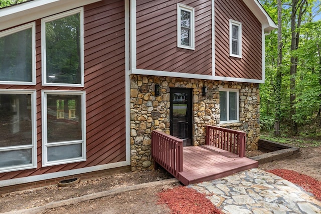 rear view of property featuring stone siding