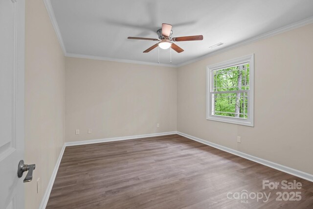 spare room with baseboards, wood finished floors, visible vents, and ceiling fan