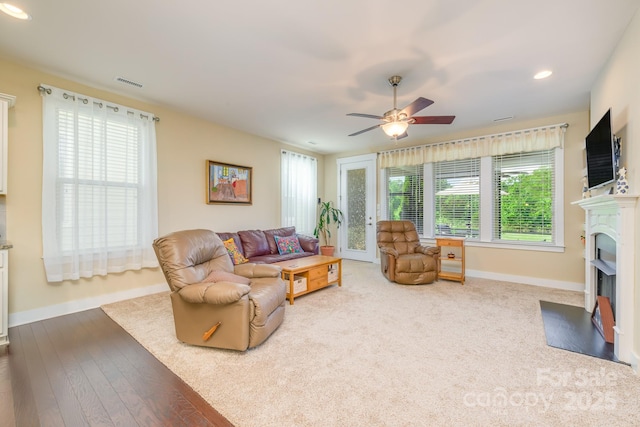 living area featuring baseboards, a fireplace, a ceiling fan, and recessed lighting