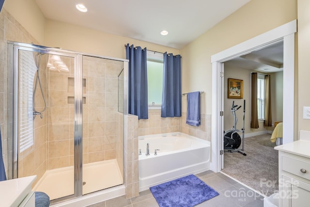 full bathroom with a shower stall, vanity, a bath, tile patterned flooring, and recessed lighting