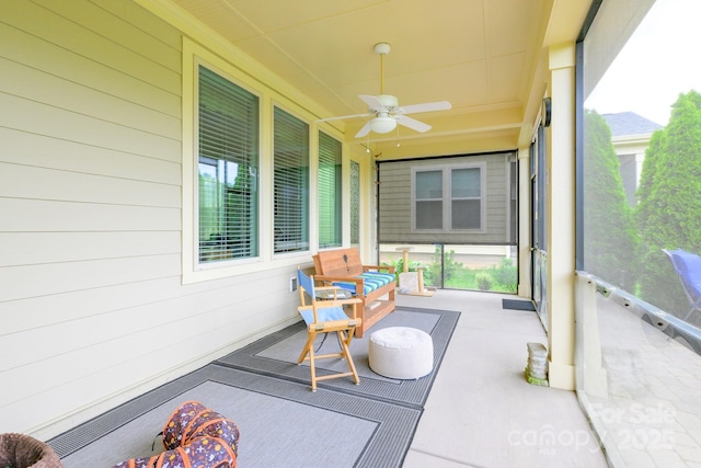 sunroom / solarium with a ceiling fan and plenty of natural light