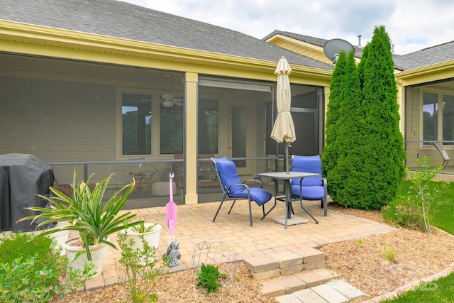 view of patio / terrace featuring grilling area and a sunroom