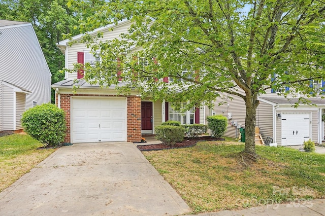 view of property hidden behind natural elements featuring driveway and brick siding
