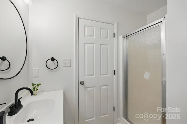 bathroom with a stall shower and vanity