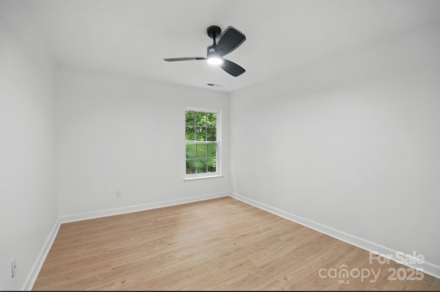 unfurnished room with visible vents, ceiling fan, light wood-style flooring, and baseboards