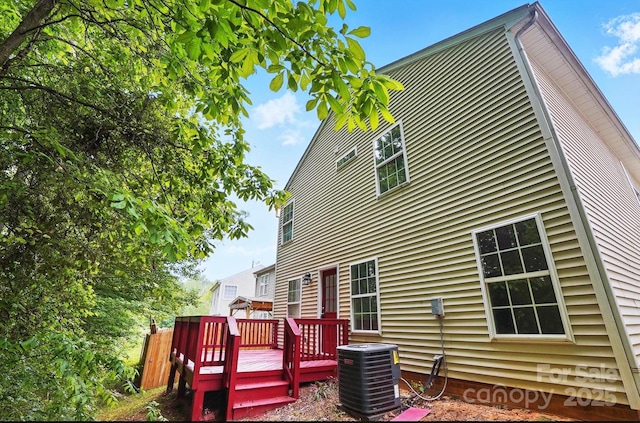 rear view of property with a deck and central air condition unit