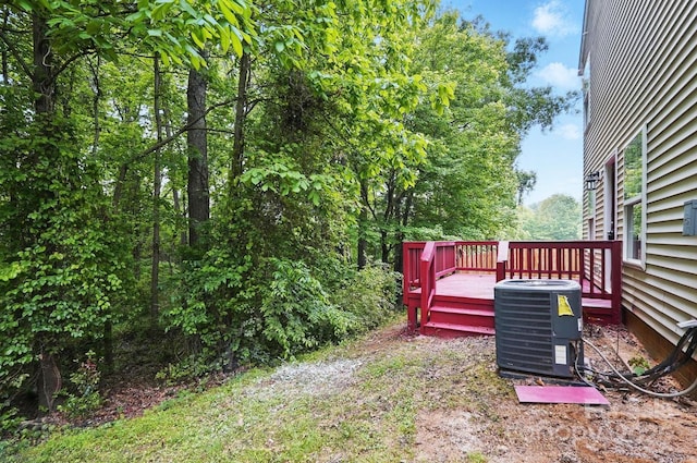 view of yard with a deck and central AC unit