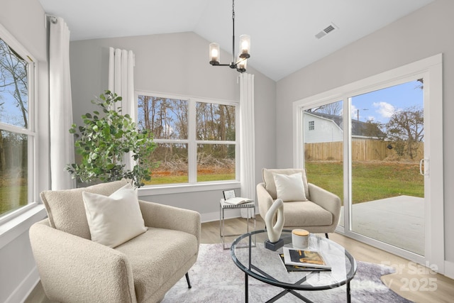 sunroom / solarium featuring visible vents and a chandelier