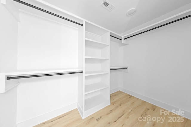 walk in closet featuring wood finished floors and visible vents