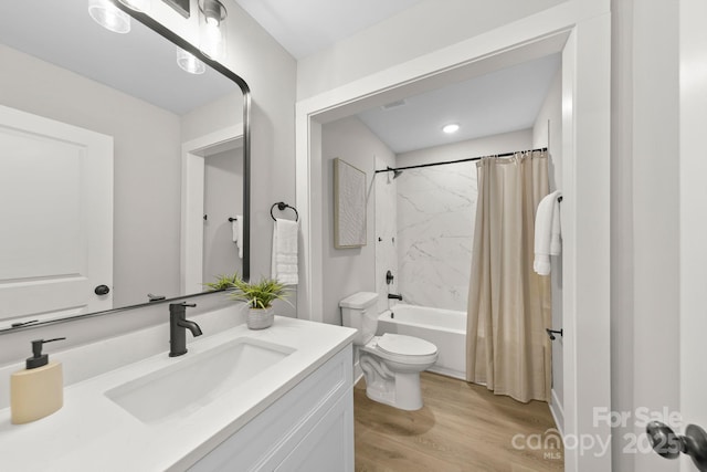 bathroom with shower / bath combo, wood finished floors, toilet, and vanity