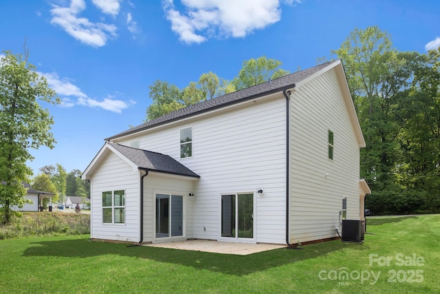 back of house with a shingled roof, a yard, central air condition unit, and a patio