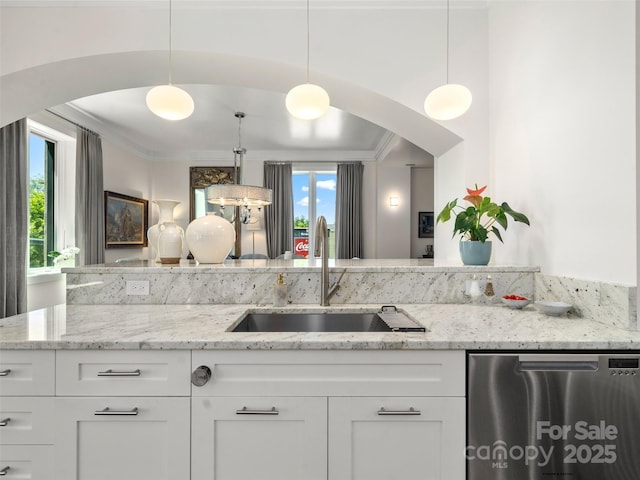 kitchen featuring dishwasher, white cabinets, arched walkways, and a sink