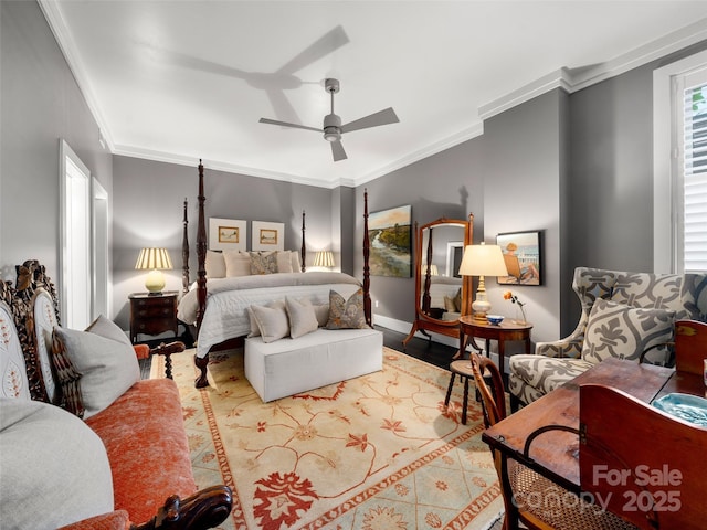 bedroom featuring wood finished floors, crown molding, baseboards, and ceiling fan