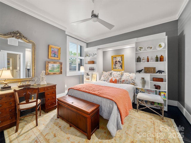 bedroom featuring wood finished floors, baseboards, and crown molding