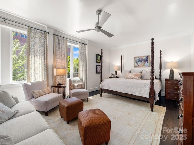 bedroom featuring light wood-style floors, a ceiling fan, multiple windows, and ornamental molding