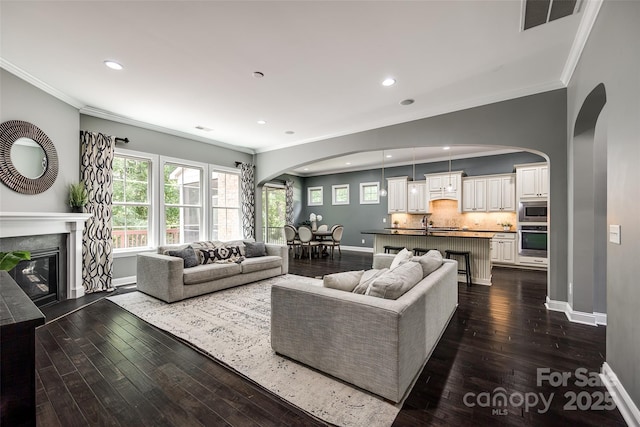 618 Chase Ct, Fort Mill, SC 29708 - living area featuring arched walkways, ornamental molding, baseboards, dark wood finished floors, and recessed lighting