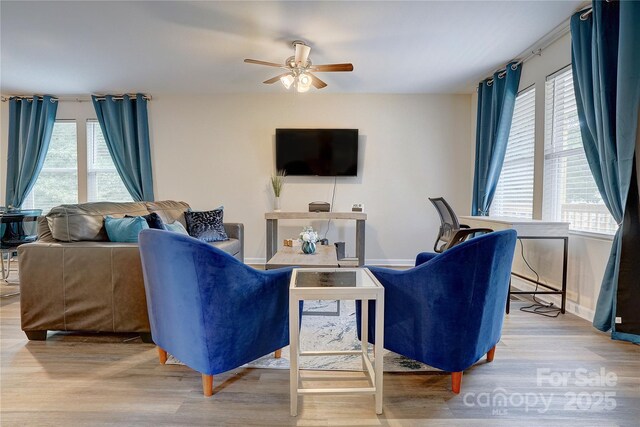 living area with ceiling fan and wood finished floors