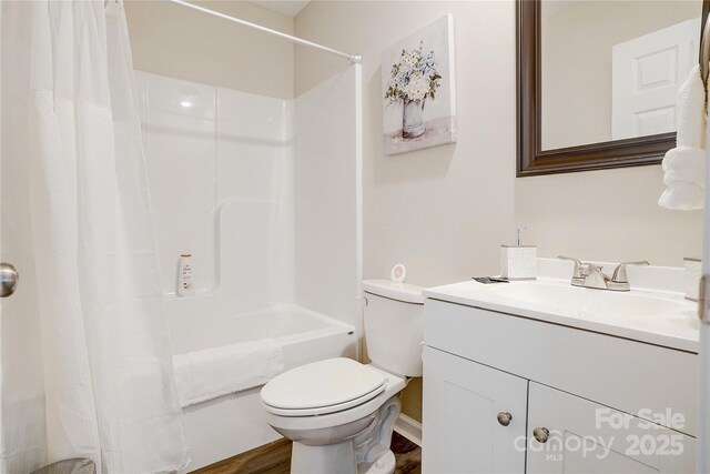 bathroom featuring toilet, shower / bath combination with curtain, wood finished floors, and vanity