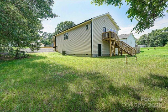 back of property featuring stairs, a lawn, crawl space, and a deck