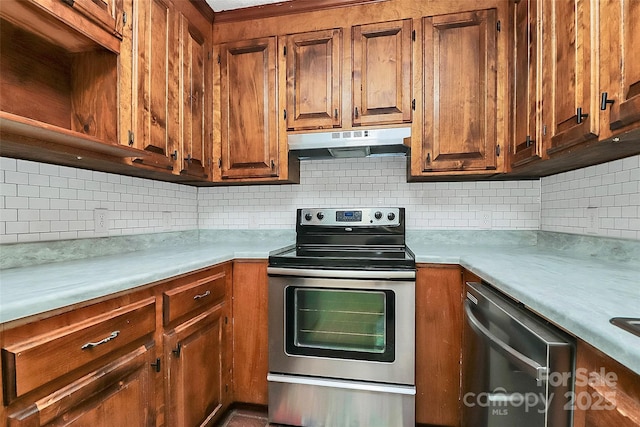 kitchen with backsplash, light countertops, appliances with stainless steel finishes, and under cabinet range hood