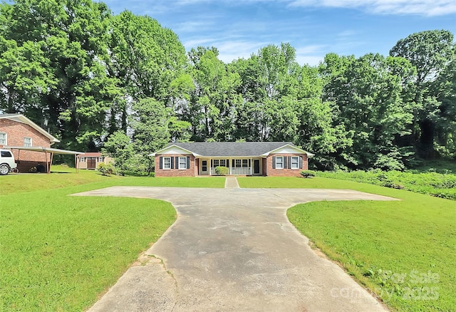 ranch-style house with a front lawn, brick siding, and curved driveway