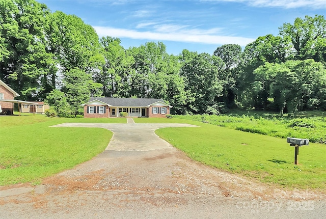 ranch-style home featuring driveway and a front yard