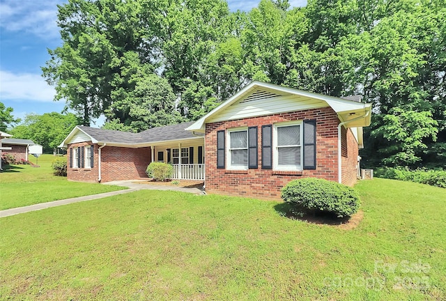 ranch-style home featuring a front lawn, brick siding, and a porch