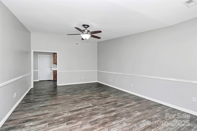 unfurnished room featuring baseboards, ceiling fan, visible vents, and dark wood-style flooring