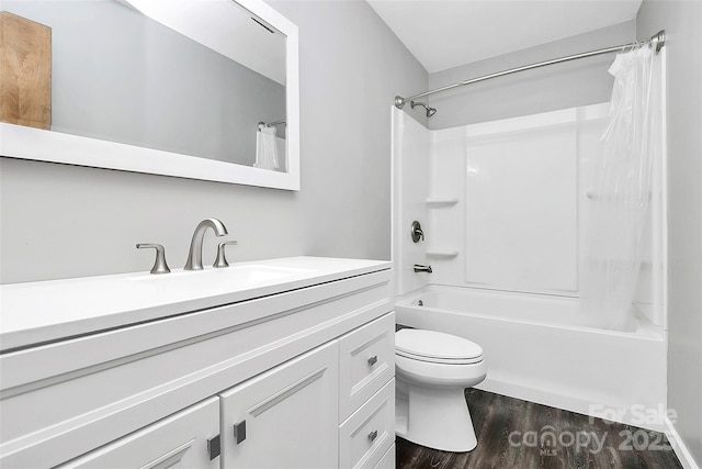 full bathroom with toilet, shower / tub combo with curtain, wood finished floors, and vanity