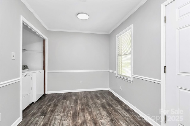 empty room with baseboards, ornamental molding, washing machine and dryer, and dark wood-style floors